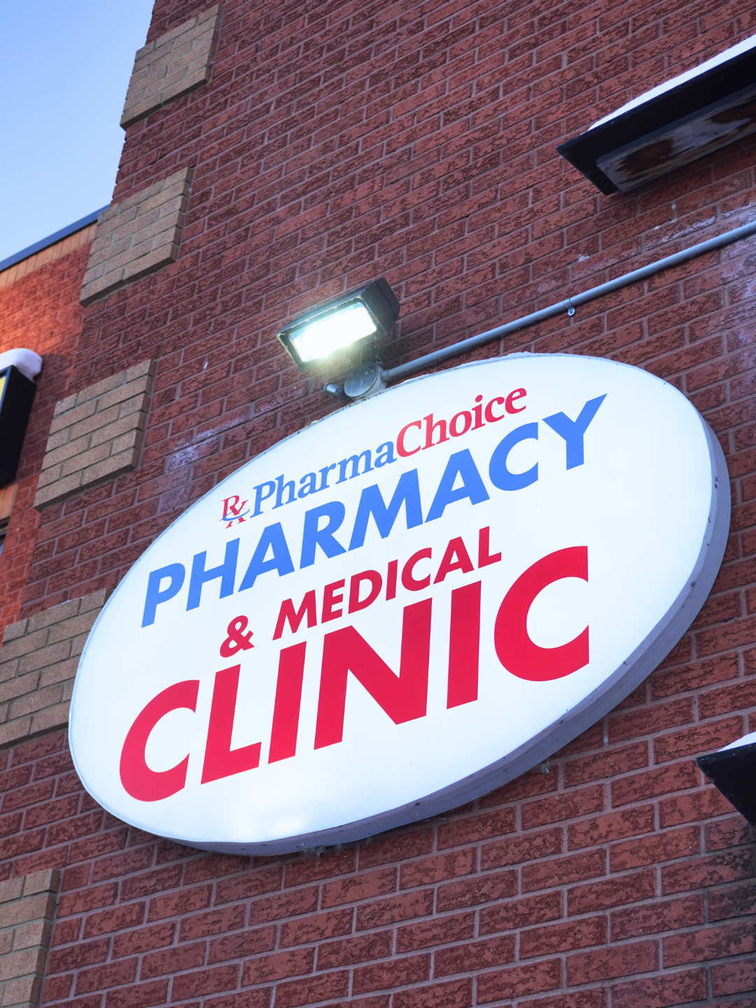 PharmaChoice Pharmacy & Medical Clinic illuminated sign on the storefront at 329 March Road